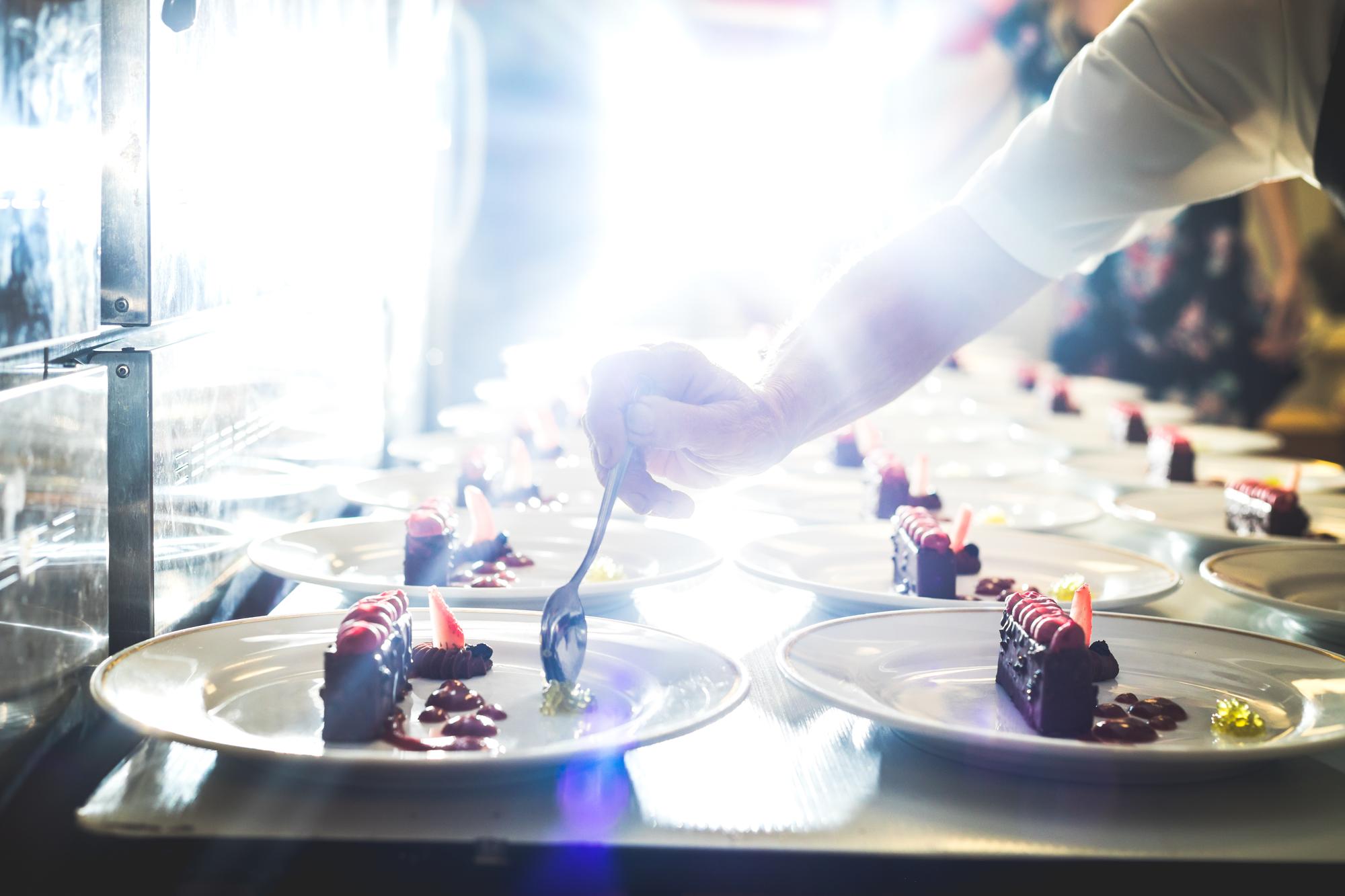 Participants tasting a plated course under soft lights